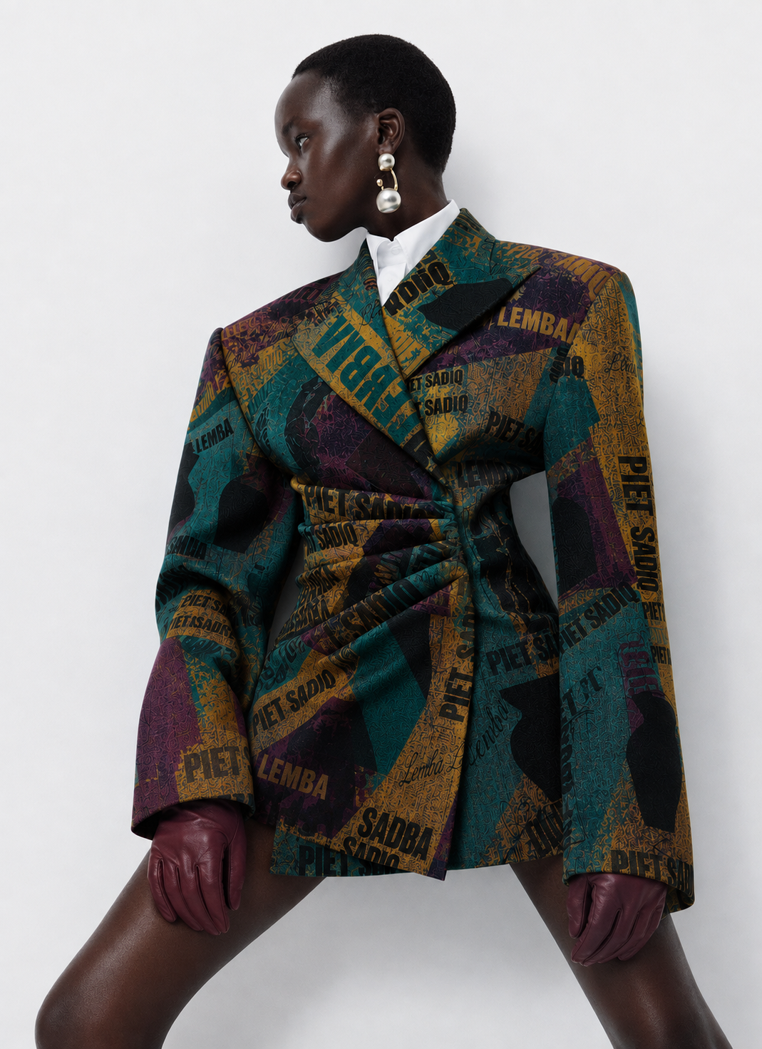 Structured, oversized blazer in the Vha’Lemba print featuring teal, mustard yellow, purple, and black.